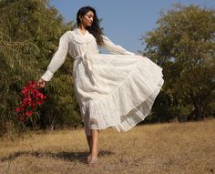 This beautiful white on white printed dress is made in #sheer cotton-silk from Banaras, India. It has a collared neckline with hand-embroidered frill trims and buttons till the waist. The sleeves are gathered and end in a wide cuff with frill trims and buttons. With a tiered flare, this dress is feminine and comfortable to move in. The dress comes with an adjustable waist tie finished with neatly hand-embroidered frill trim. A treat for all women who possess a #romantic style! The print, embroid White Printed Dress, Cotton Silk Dress, White Print Dress, White On White, Jaipur Rajasthan, Wide Cuff, Romantic Style, Printed Dress, Cotton Silk