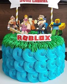 a birthday cake with legos on top and a sign that says roblox