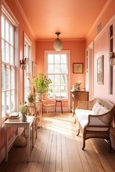 a living room filled with lots of furniture next to a window covered in plants and potted plants