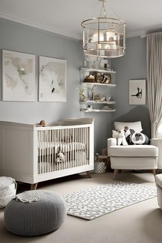 a baby's room with gray walls and furniture