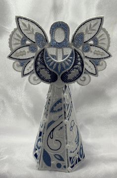 an ornament with blue and white designs on it's head is shown