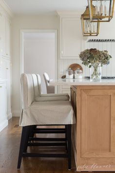 a kitchen with an island and chairs in it