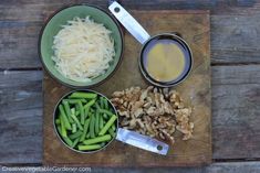 some food is sitting in bowls on a cutting board