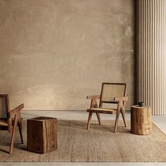 two wooden chairs sitting next to each other in front of a wall with columns on it