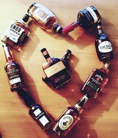 several different types of liquor arranged in the shape of a heart