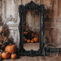 a mirror sitting on top of a wooden floor next to pumpkins