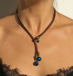 "Lariat necklace, leather necklace, stone necklace, necklace for woman belong to bohemian jewelry as well as boho jewelry. A gemstone jewelry piece carefully designed and crafted by EndiaDesign. Show off a bohemian style with this unique leather necklace made of high quality cow leather, agates stones in blue colour and a beads in antique bronze tone. You could wear this original gemstone necklace on any occasion, formal or casual, making you look super chic and cute. Agate Healing Properties ♥ Bohemian Festival Lariat Necklace With Adjustable Chain, Bohemian Lariat Necklace As Gift, Bohemian Lariat Necklace With Sliding Knot, Bohemian Lariat Choker Necklace, Unique Adjustable Lariat Necklace, Unique Adjustable Length Necklaces, Unique Necklaces With Adjustable Length, Adjustable Cord Long Necklace, Festival Lariat Necklace With Natural Stones