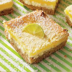 several pieces of cake on a green and white striped tablecloth with lime wedges