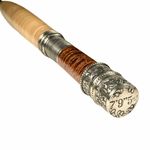 a wooden and metal pen with an ornate design on the top, sitting in front of a white background