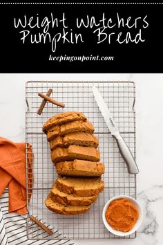 pumpkin bread on a cooling rack with cinnamon sticks