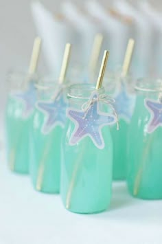 small jars with straws and starfish decorations on them