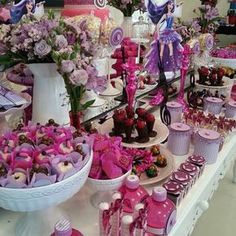 a table filled with lots of cupcakes and cakes