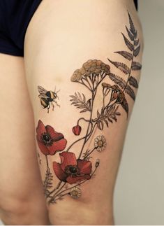 a woman's thigh with flowers and a bee on it