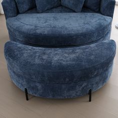 a large blue chair and ottoman in a room