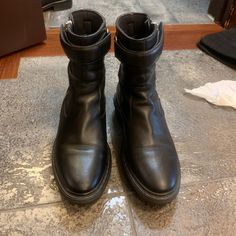 Balenciaga Lug Sole Black Leather Boots With Strap. Worn Several Times, Medium Signs Of Wear. Slight Creasing And Scuff Mark. Great For Snow And Cold Weather. Shoes Balenciaga, Balenciaga Black, Balenciaga Shoes, Moto Boots, Lug Sole, Black Leather Boots, Biker Boot, Cold Weather, Leather Boots