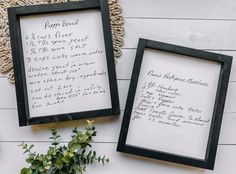 two framed pictures with writing on them next to a potted plant