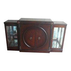 an old wooden cabinet with glass doors