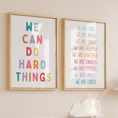 two framed art prints on the wall above a crib in a child's room