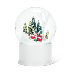 a snow globe with trees and a red truck in the middle is shown on a white base