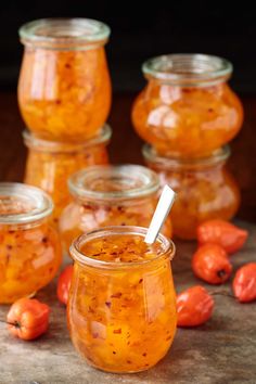 several jars filled with food sitting on top of a table