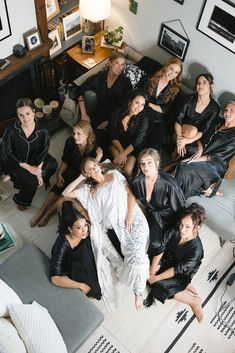 a group of women sitting on top of a couch in a living room next to each other