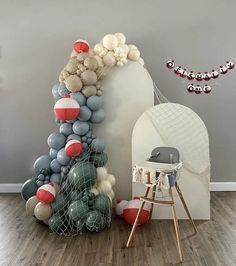 a balloon arch and chair in a room