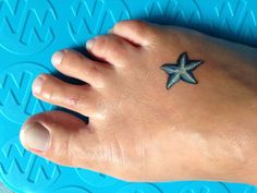 a small starfish tattoo on the foot of a person's left foot,