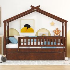 a child's bed with a wooden frame and mattress in a room that has white walls