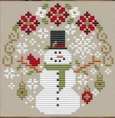 a cross stitch snowman with flowers on it