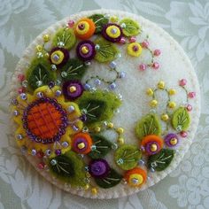 this is an image of a brooch with flowers on it's back side