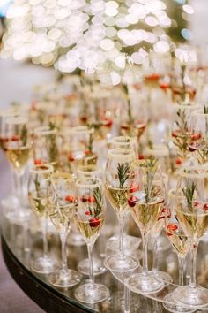 many wine glasses are lined up on a table