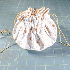 a drawstring bag sitting on top of a cutting board