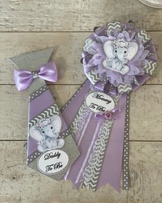 some purple and silver items on a wooden table with a name tag attached to one of them