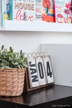 two baskets with plants sit on a shelf next to a sign that says now and then