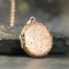 "A beautiful round locket is adorned with a floral design on the front.   The locket opens to hold photos or memories of your choosing. This round locket is made in stainless steel and is available in your choice of silver, rose or yellow.   It measures approximately 1\" (25mm) in diameter and hangs from a coordinating stainless steel chain approximately 20\" in length.    This would make a lovely keepsake for your sweetheart! - something that she could treasure and wear for many years. This locket can be engraved with your choice of personalization on the back.   Engraving will be best if you choose a short phrase, a date, names, etc.   Keep the message short as there is limited space!  Please expect subtle variances in each pendant due to handmade characteristics.   The piece you receive Elegant Round Locket Necklace With Birth Flower, Elegant Round Pendant Locket Necklace With Birth Flower, Elegant Birth Flower Round Pendant Locket Necklace, Engraved Rose Gold Pendant Locket Necklace, Engraved Rose Gold Locket Necklace With Round Pendant, Engraved Rose Gold Round Pendant Locket Necklace, Rose Gold Round Locket Necklace, Rose Gold Locket Necklace For Anniversary, Rose Gold Round Locket Necklace For Gifts