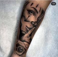 a woman's arm with a black and white tattoo design on the left forearm