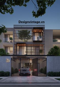 an apartment building with large windows and metal bars on the front door, at night