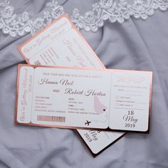 two pink and white boarding cards with lace on the bottom one is for a destination