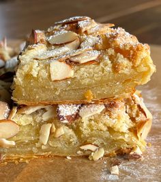 three pieces of cake sitting on top of a wooden table covered in powdered sugar