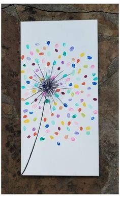 a card with confetti sprinkles on it sitting next to a stone wall