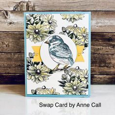 a card with a bird sitting on top of flowers and the words swap card by annie call