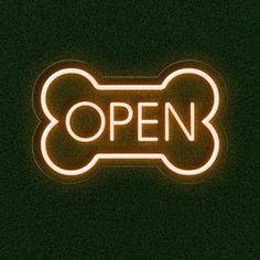 a neon sign that says open with a dog bone on it's back end