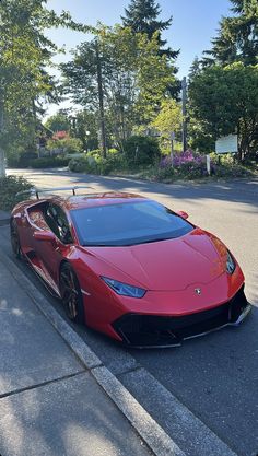 a red sports car parked on the side of the road