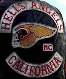 a man wearing a leather jacket with the words hells angels and california on it