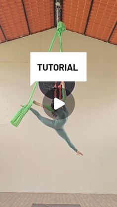 a woman is doing aerial tricks on a trampoline in an indoor gym area