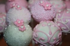 there are many pink and white cake balls