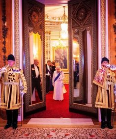 the queen and prince are standing in front of an ornate doorway at their wedding ceremony