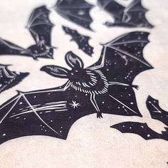 the bat is flying through the night sky with stars on it's back end