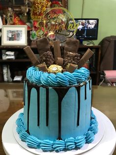 a blue cake with chocolate and candy on top