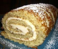 there is a cake roll with icing and powdered sugar on it